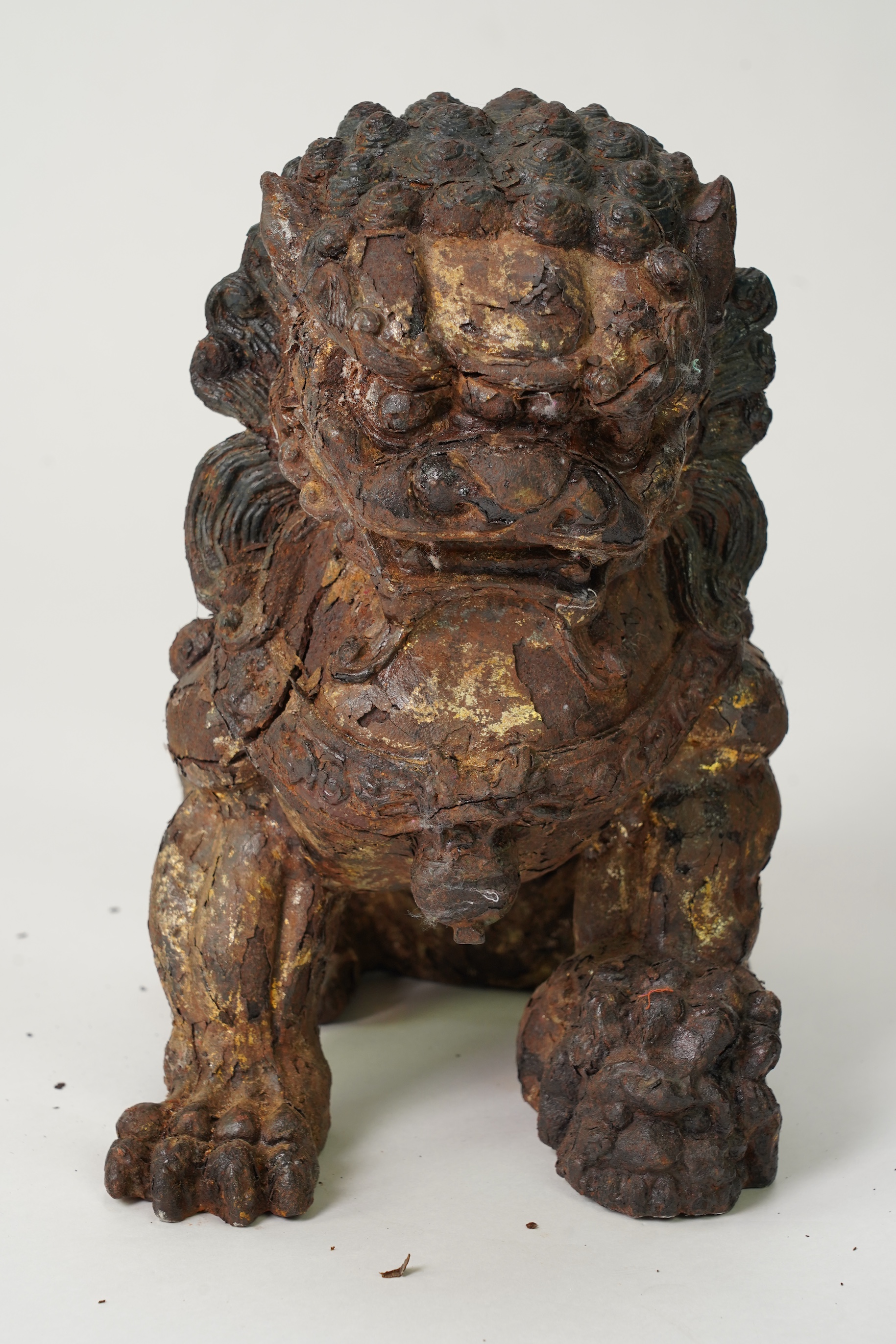 A pair of large Chinese polychrome lacquered cast iron models of lion temple guardians, Qing dynasty